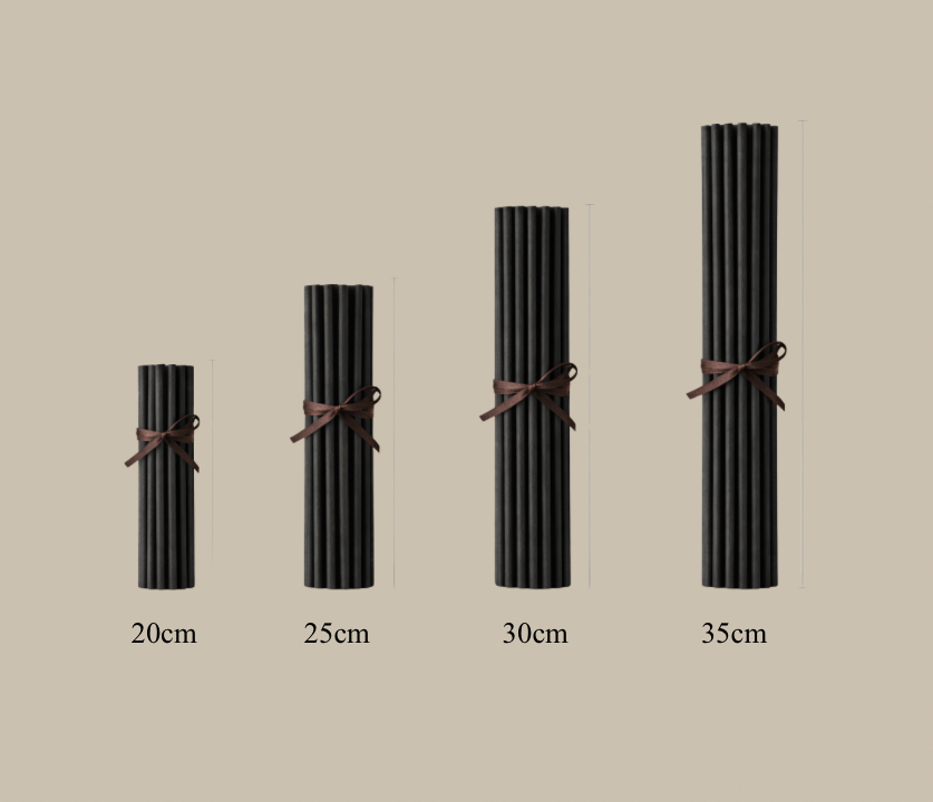 Set of black candles with brown ribbons on a beige background, labeled with their lengths.